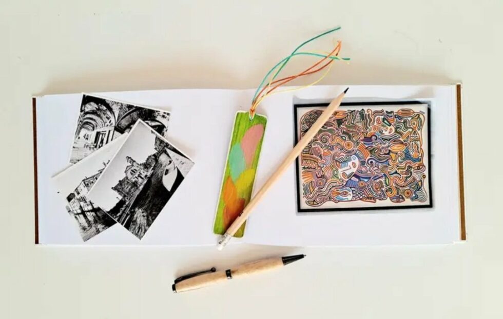 Carnet VERGER vue intérieure avec reliure orange et marque-pages en bois et stylo en bois.